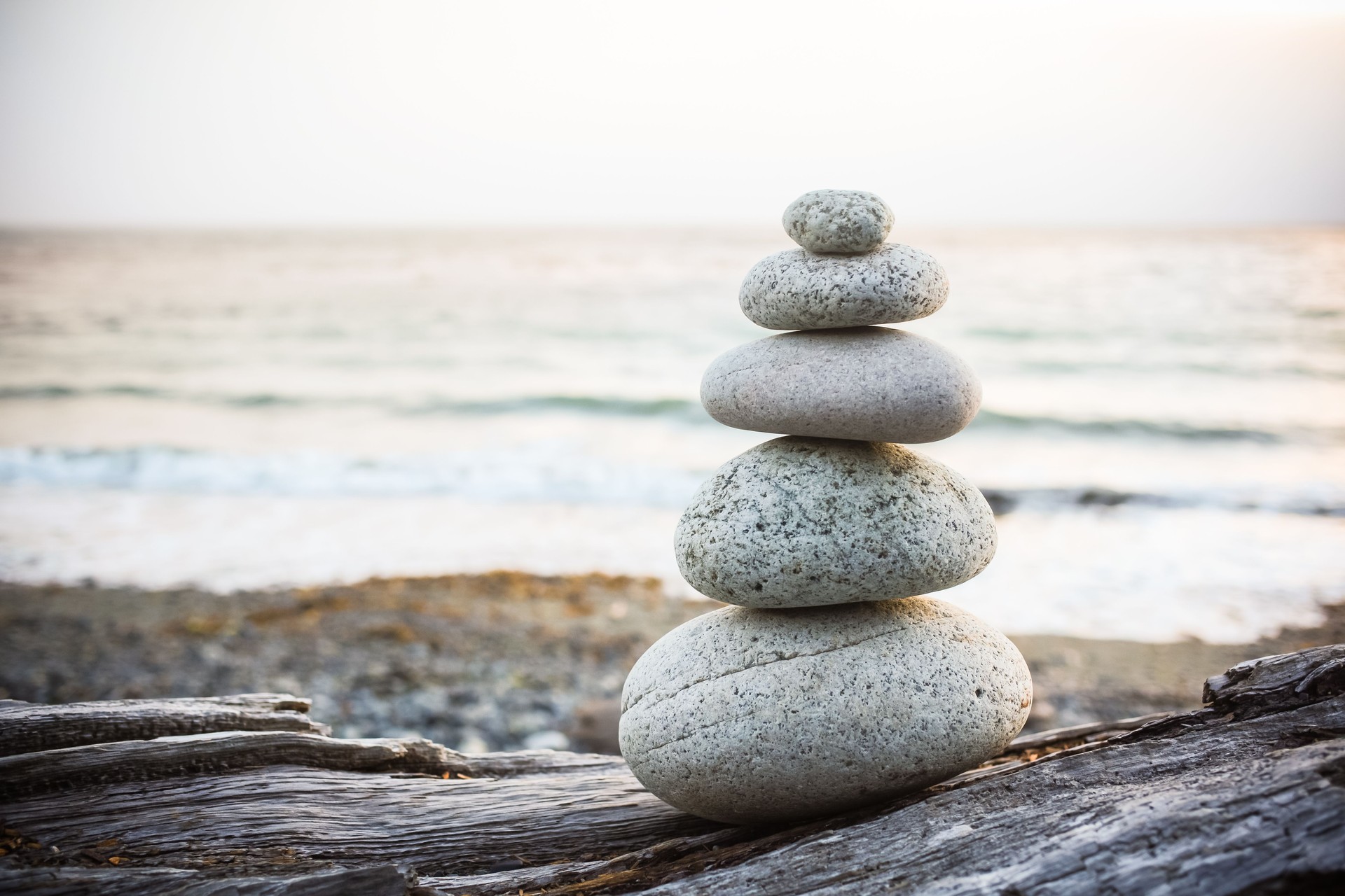 Inukshuk Cairn on driftwood on beach
